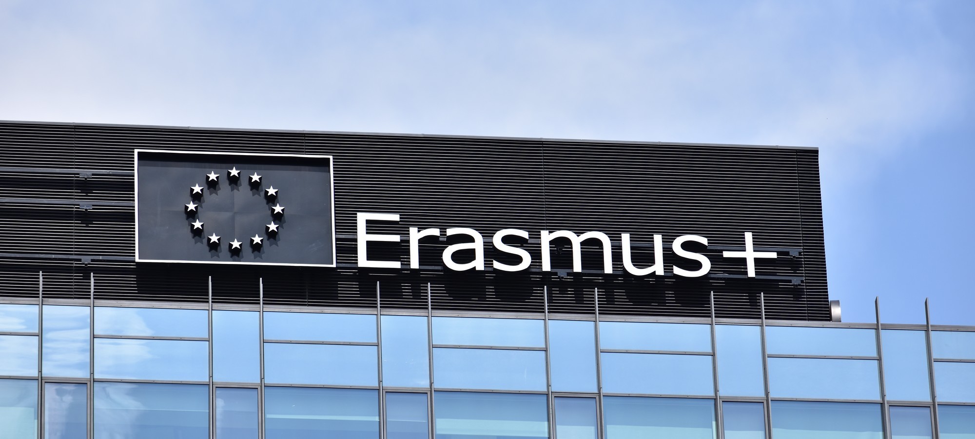 Erasmus+ logo, emblem, signage on the facade. Student exchange programme in Europe. WARSAW, POLAND - JULY 26, 2024
